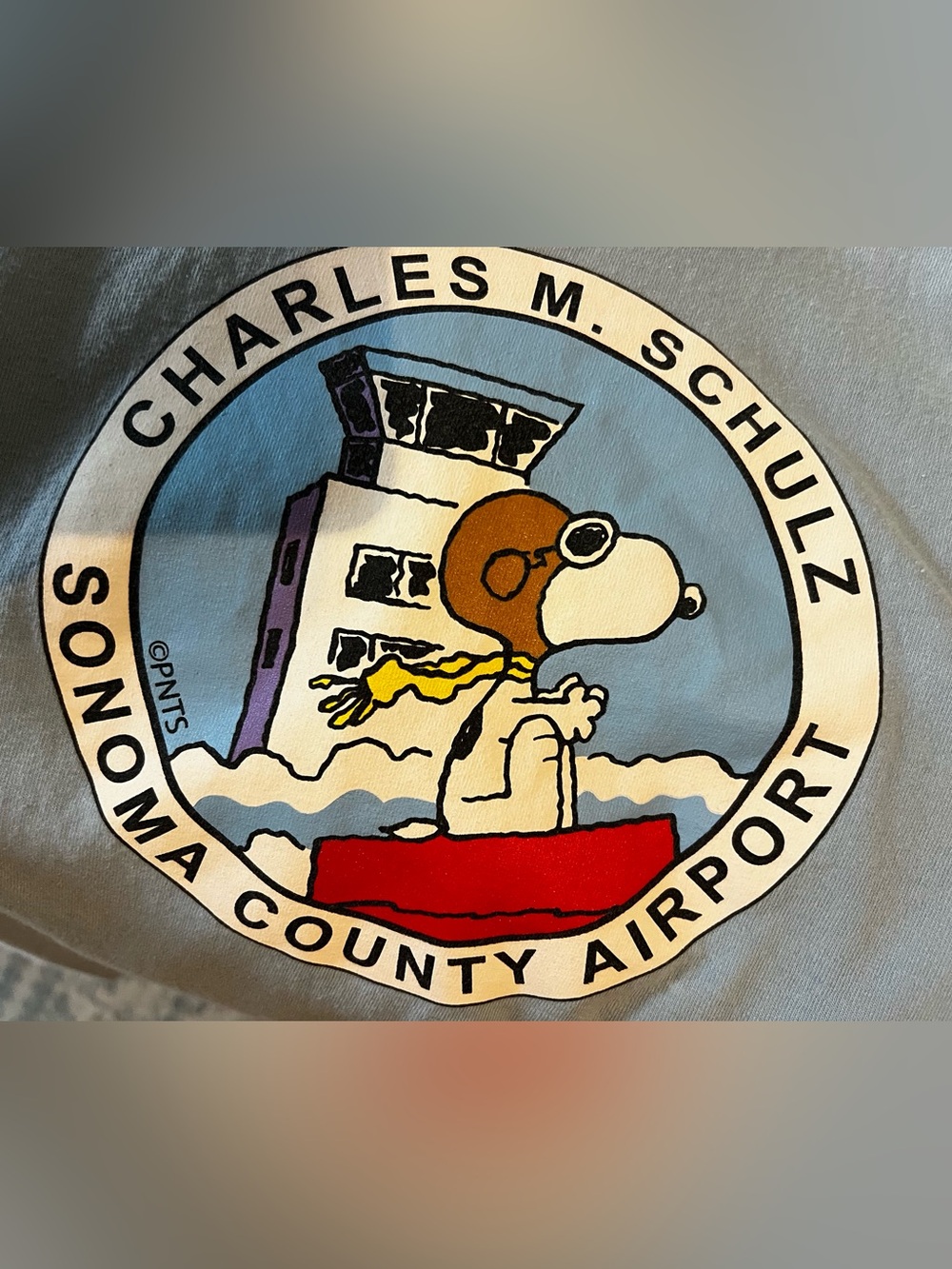 Charles M. Schulz Sonoma County Airport Snoopy Graphic Tee - Light Blue